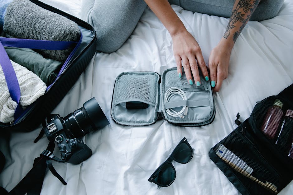 Backpack and travel accessories neatly organized on a bed