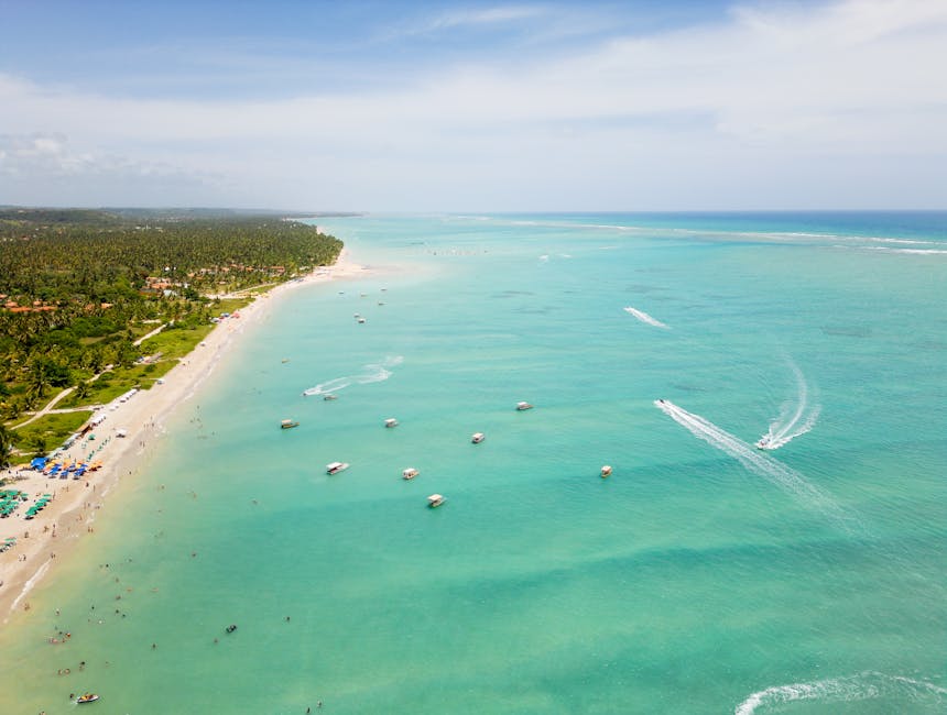 Brazilian beach with clear blue water and boats