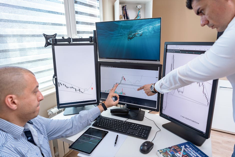 business professional analyzing data on multiple screens