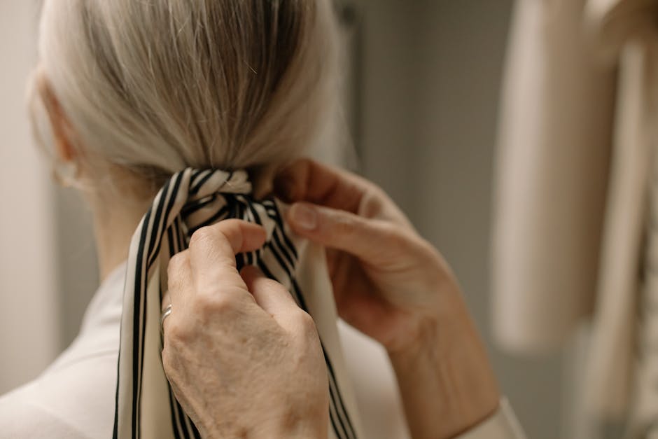 close up of woman tying a silk scarf
