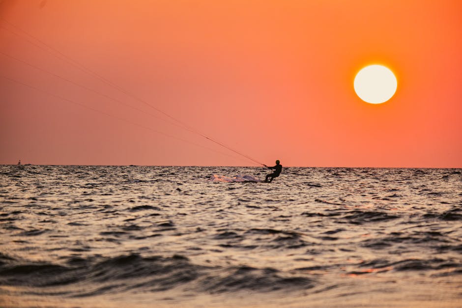 couple kitesurfing sunset