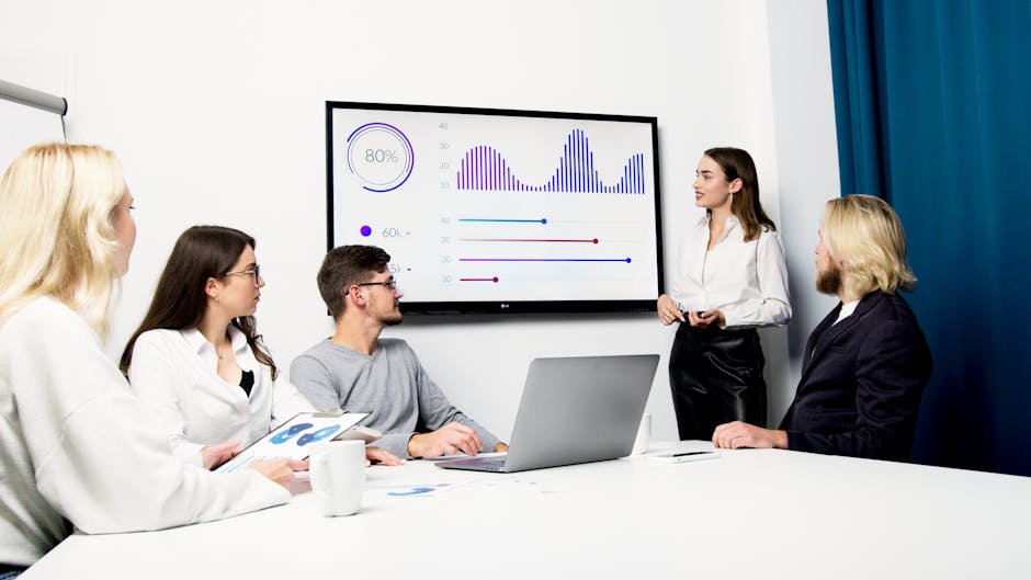 diverse team collaborating on a digital presentation, charts and graphs on screen
