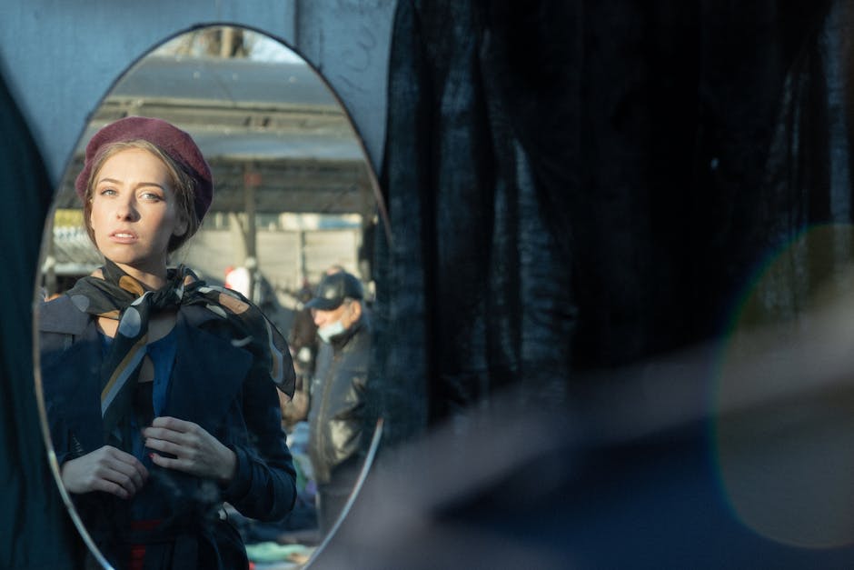 elegant woman adjusting scarf in front of mirror