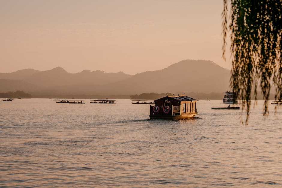 Houseboat on tranquil lake at sunset