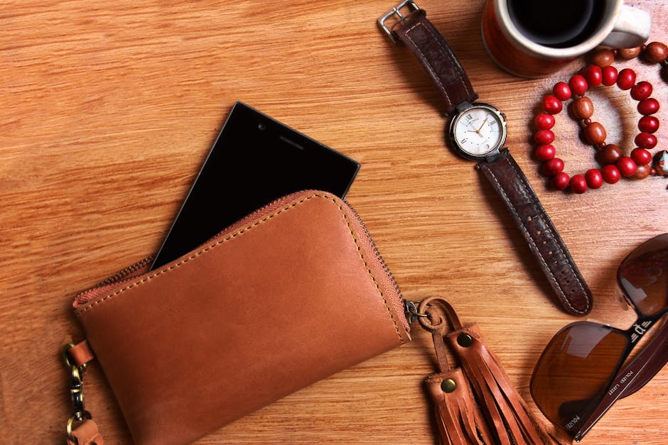 jewelry and leather accessories on a wooden table