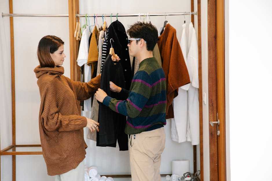 man choosing clothes from organized closet