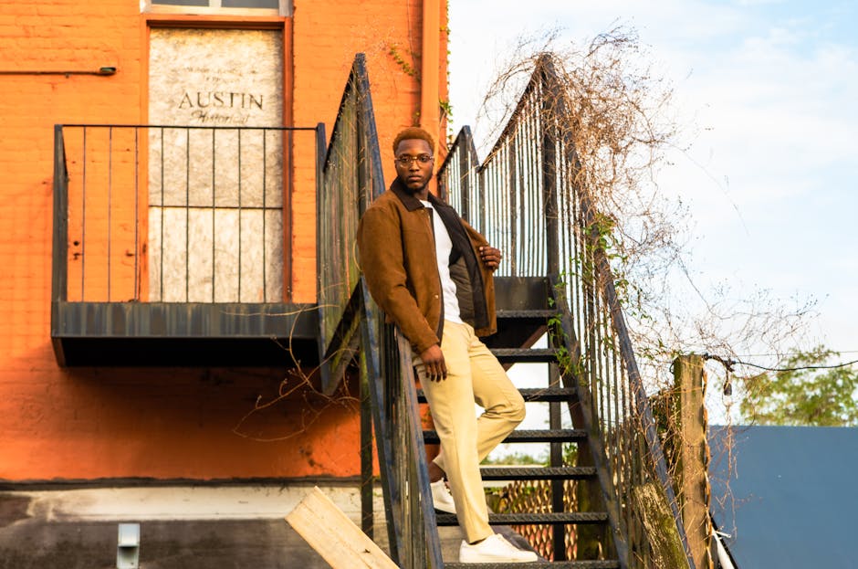 man in stylish outfit sitting on stairs