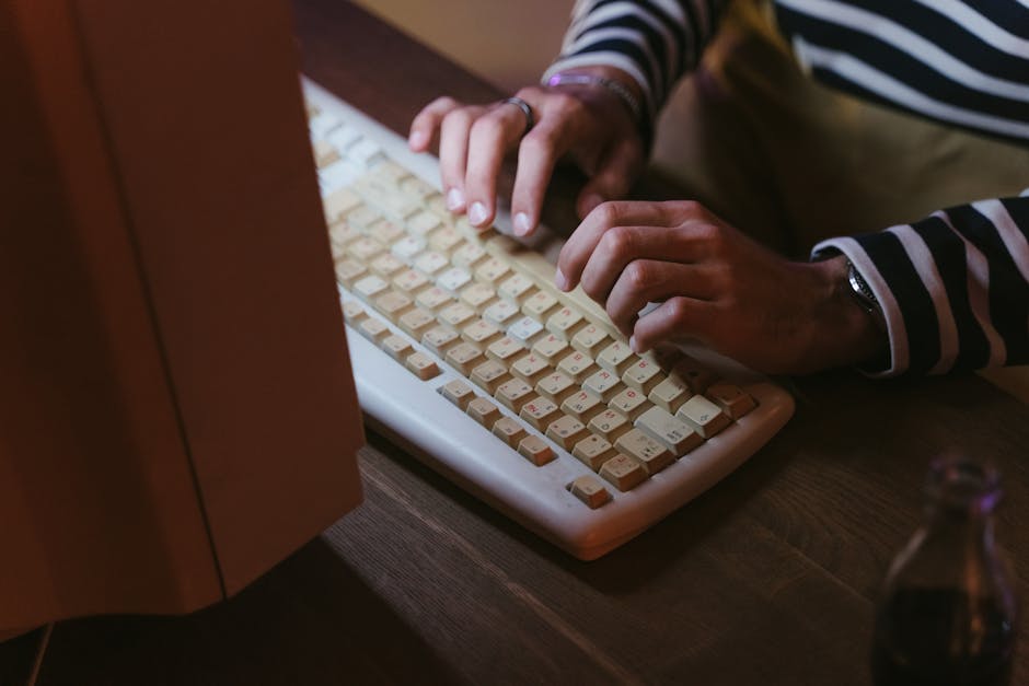 person typing on computer keyboard
