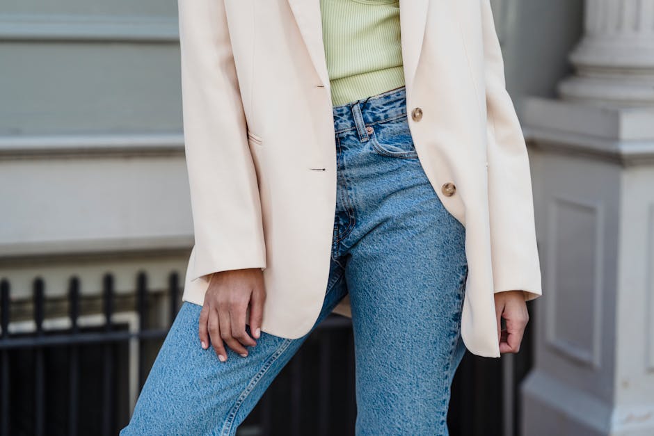 stylish woman wearing tailored blazer and jeans in a city street