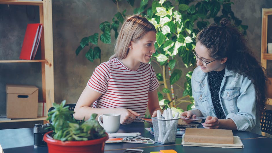 two people discussing ideas in modern office