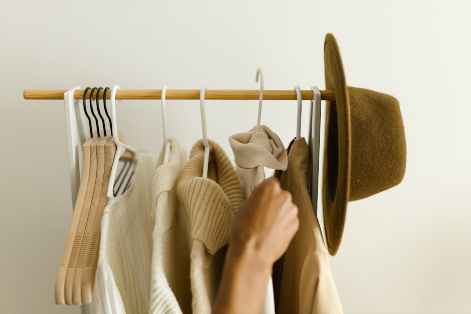 wardrobe closet with organized clothes neutral colors