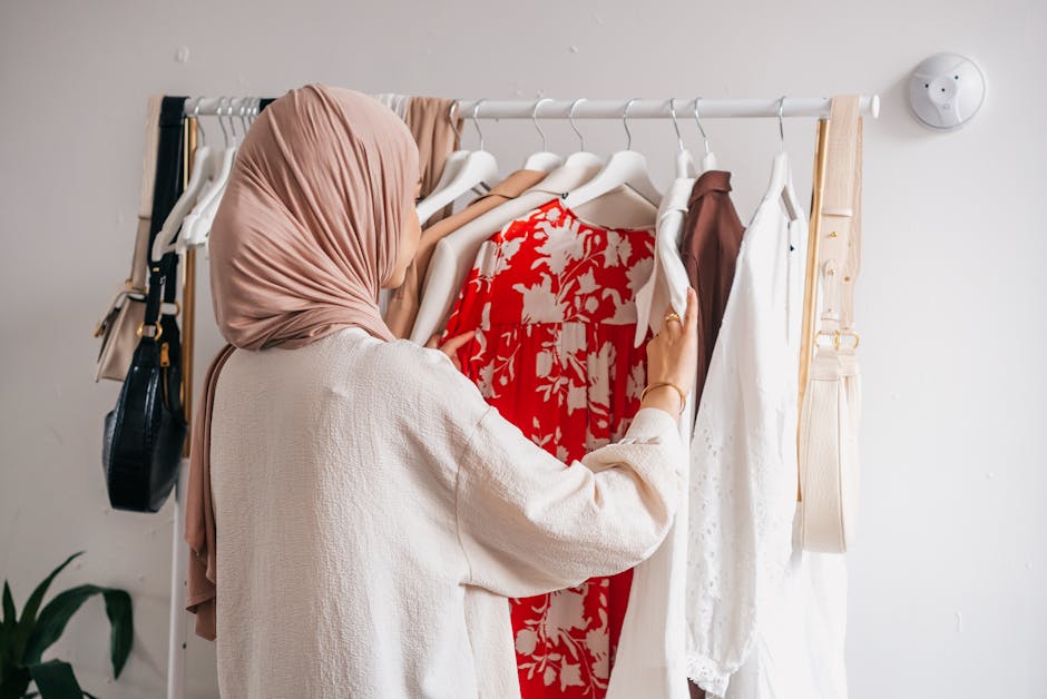 woman choosing outfit from organized closet