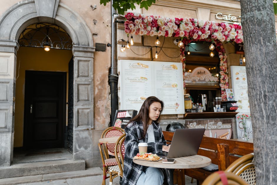 woman working on laptop in cafe