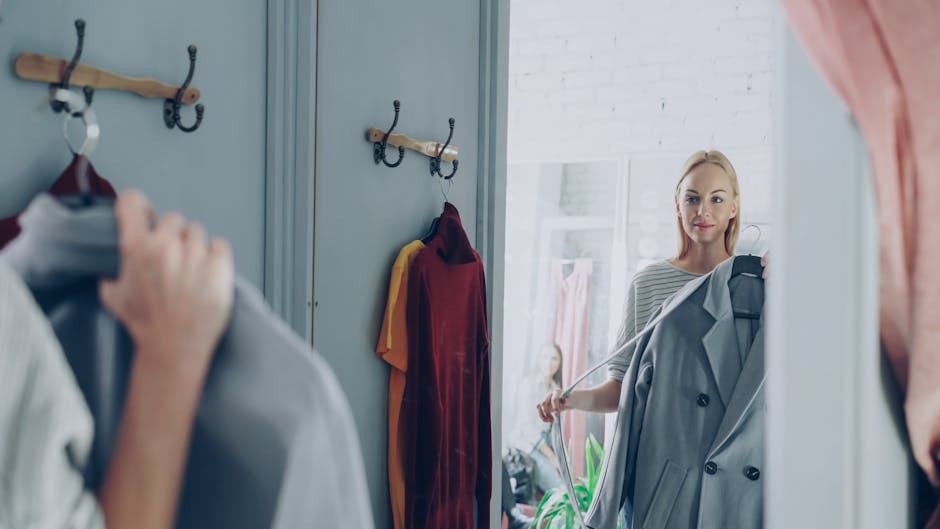 young woman trying on jacket in boutique